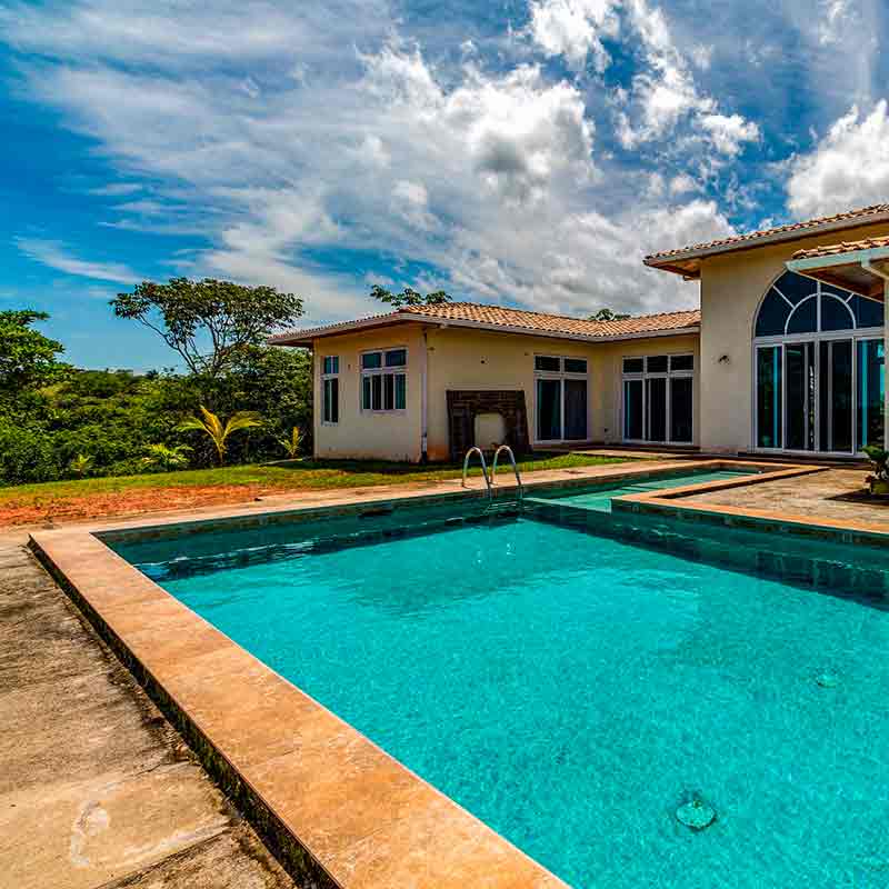 Piscina rectangular junto a casa de campo